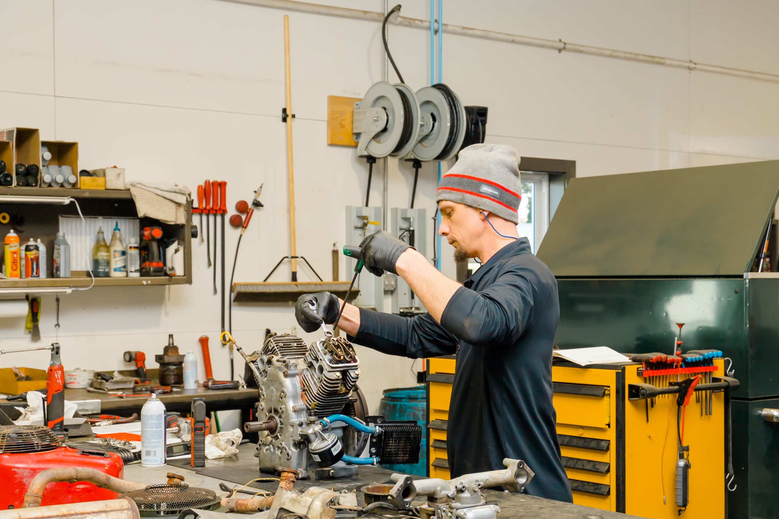 SteveCo employee working on an engine.